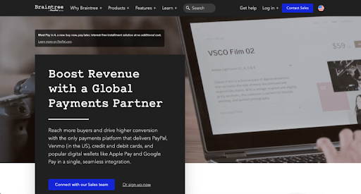 A marketing website including a person typing into an open laptop, that promises to boost revenue and offer a global payment partner