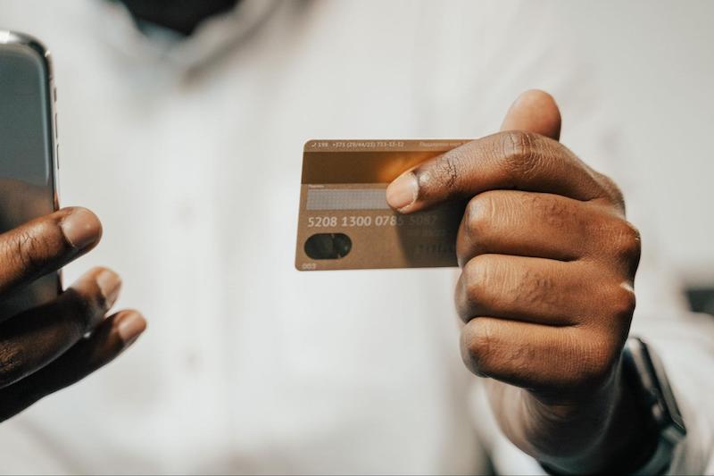 Close up of a hand holding a credit card